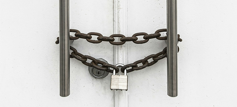 inspecting a lock before renting storage space during a business relocation in Miami