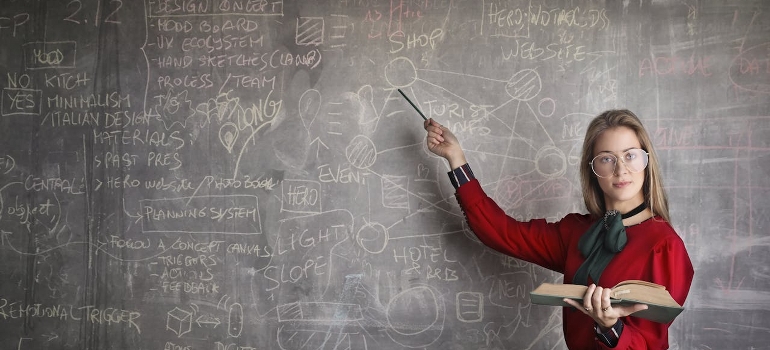 woman showing on a blackboard all about relocating with OCD