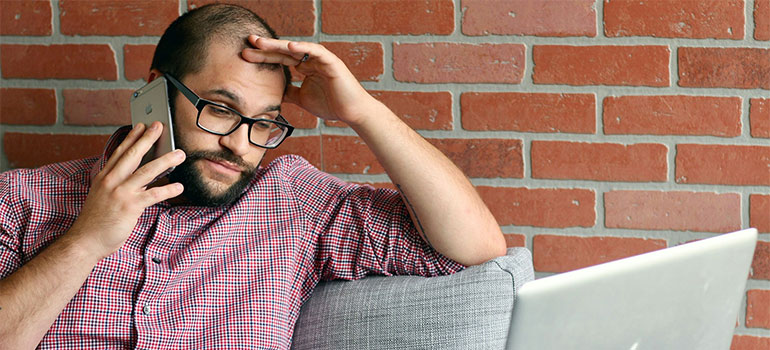 man on the phone because movers hold your belongings hostage