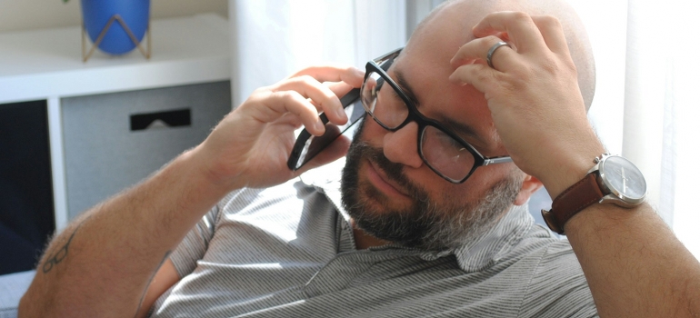 man on the phone because movers hold your belongings hostage
