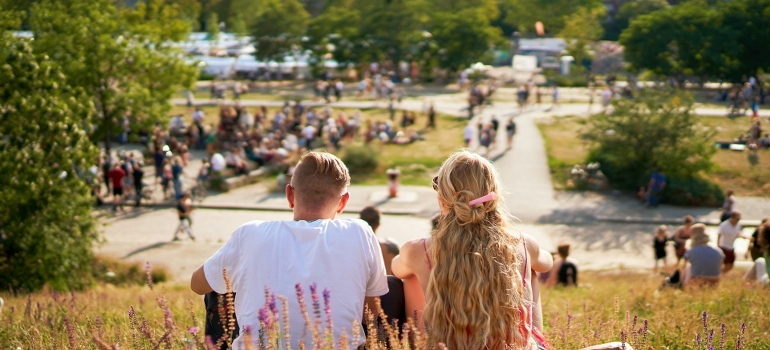 couple sitting in a park and talking about moving from Miami to Houston