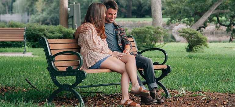 couple on a bench after moving from Miami to Dallas