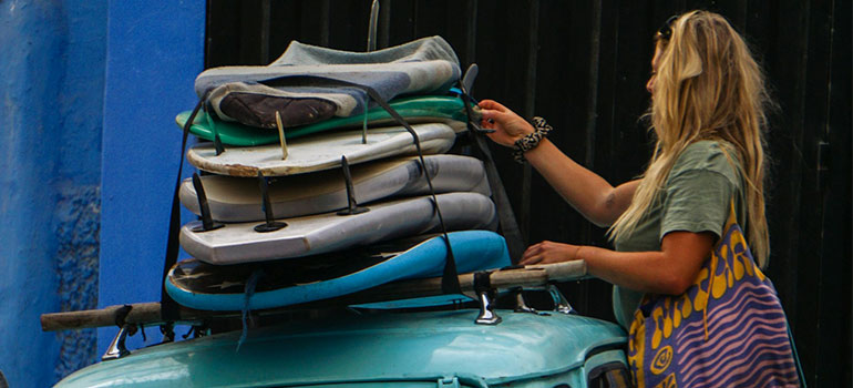 checking surfboards on a car
