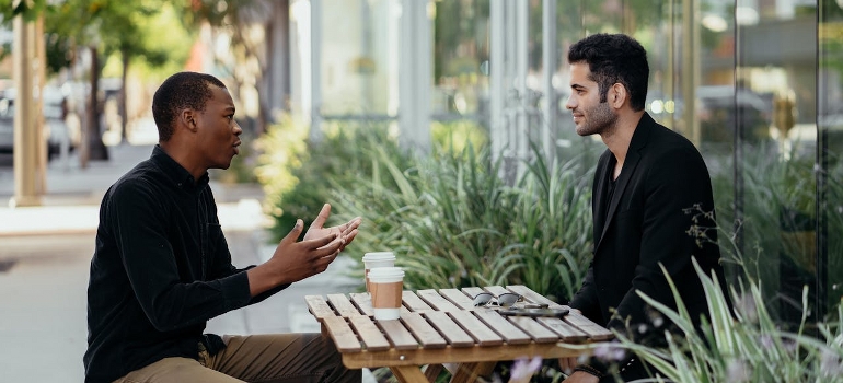 two guys sitting outside
